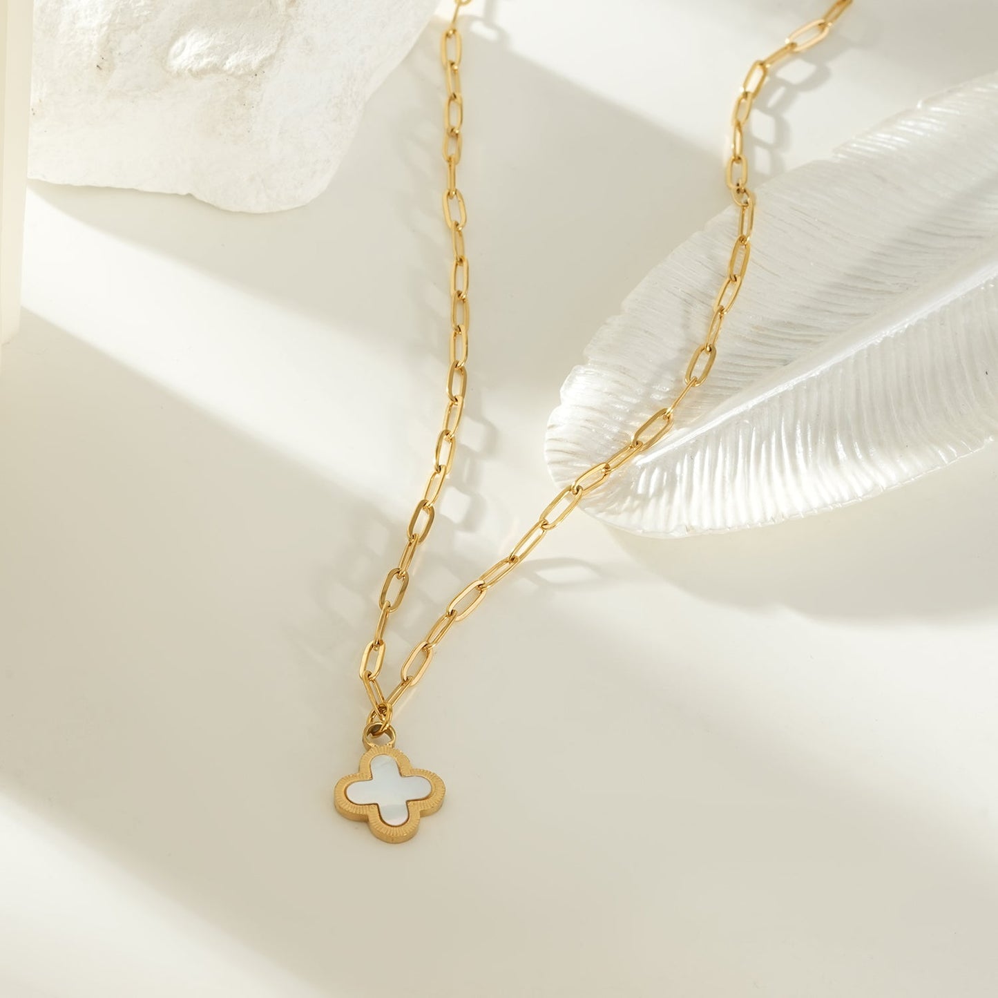 MAKA Gold: Clover Shaped Charm in Natural Shell & Gold Metal Border on a Paperclip Chain
